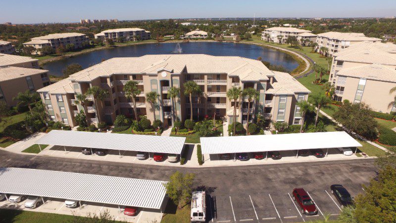 Aerial view of apartment building with parking.