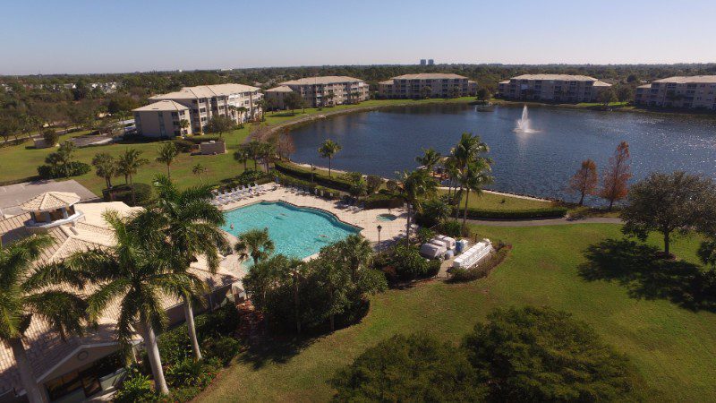 Aerial view of resort with pool and lake.